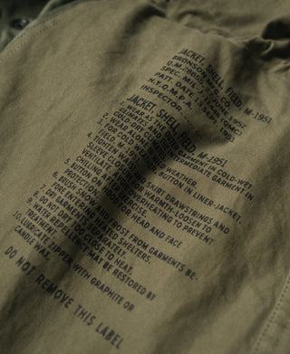 Olive field jacket inner label with jacket specs and care instructions