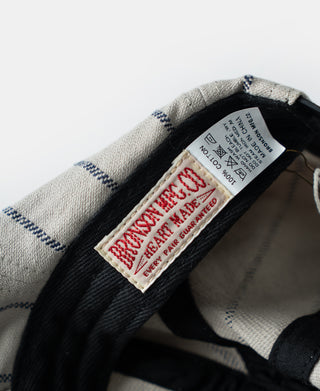 Inside care label on gray railroad stripe newsboy cap under black lining