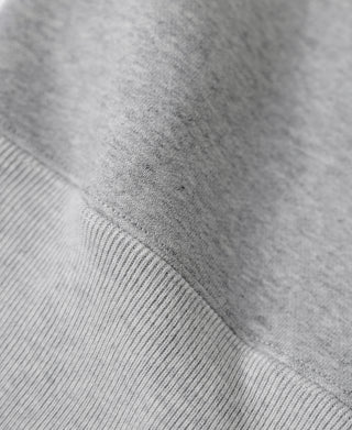 Gray fleece sweatshirt ribbed hem seam detail