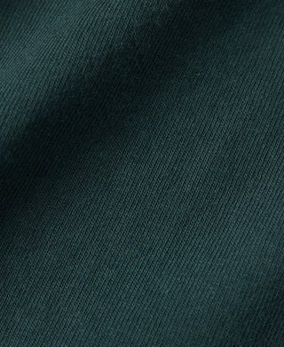 Dark green cotton t-shirt fabric knit texture close-up