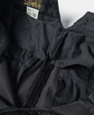 Black work pants interior waistband and stitched fly with size label.