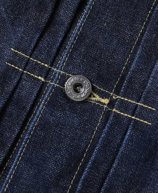 Indigo denim jacket front snap with engraved metal button and yellow stitching