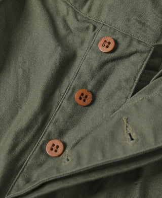 Olive bermuda shorts with stitched front pockets and brown button details