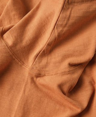 Orange crewneck pocket t-shirt neckline and pocket seam detail.