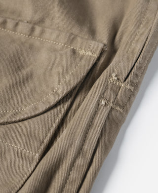Khaki bermuda shorts close-up of pocket seam and pleated fabric panels