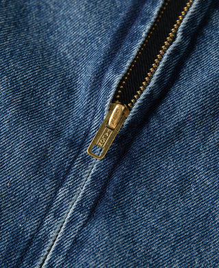 Stonewashed indigo denim work jacket zipper with gold-toned pull