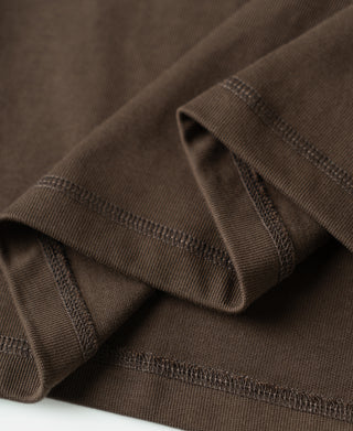 Coffee-brown henley shirt sleeve cuff and stitching seam close-up