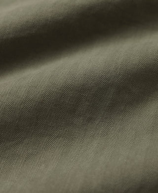Olive herringbone weave fabric texture close-up