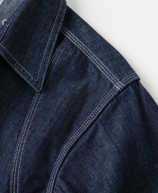 Indigo denim sleeve seam with double-stitched edging and side panel