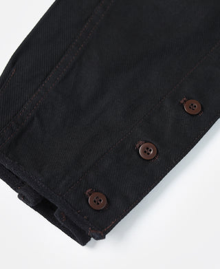 Black breeches cuff with brown buttons and contrast stitching