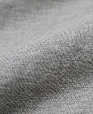 Close-up of gray hoodie knit fabric with smooth heathered texture.
