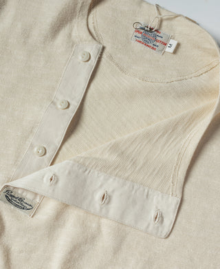 Beige henley T-shirt with button placket and shoulder snaps, front detail