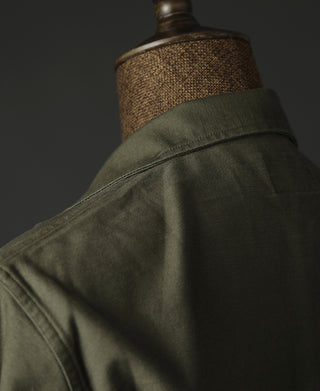 Olive shirt back close-up, fabric texture and yoke stitching detail