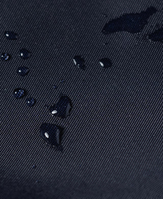 Navy ripstop nylon fabric with visible water droplets on the surface