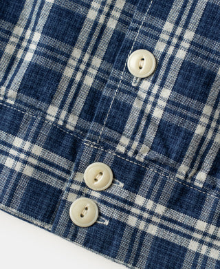 Blue plaid shirt jacket with three off-white buttons on front
