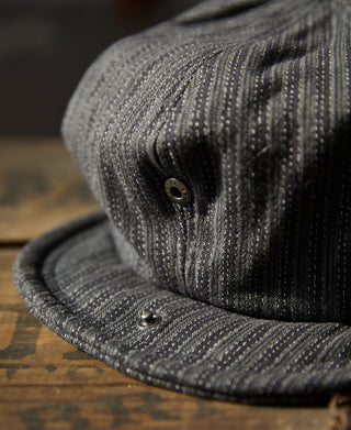 Black and gray striped newsboy cap with side buttons and curved brim.