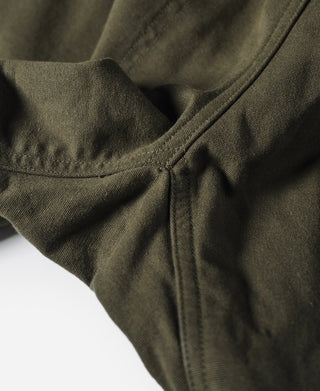 Olive canvas seam and pocket fold detail on climbing pants