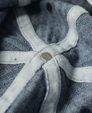 Indigo herringbone denim bucket hat interior with light strap and button