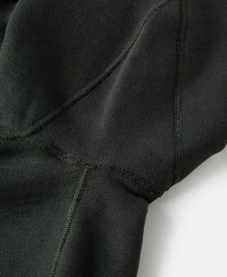 Vintage black raglan sweater close-up of sleeve seam and knit texture