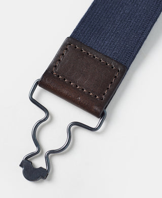 Navy suspender clip with brown leather holder and metal hook