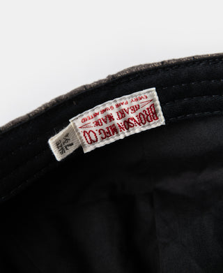 Inner tag on dark gray newsboy cap with black lining
