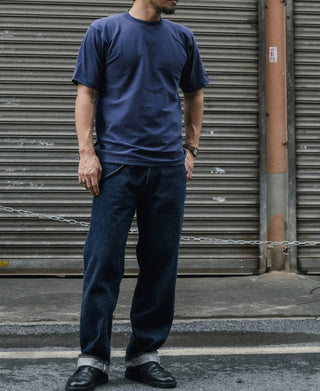 Navy crew-neck T-shirt worn with dark jeans; short sleeves and straight hem