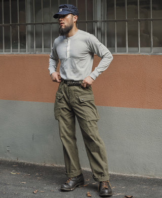 Gray long-sleeve henley shirt worn by a man, front view