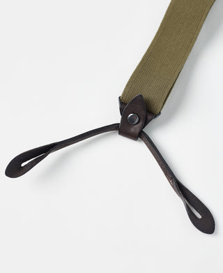 Olive webbing with dark leather Y-clip and pronged metal fastening ends