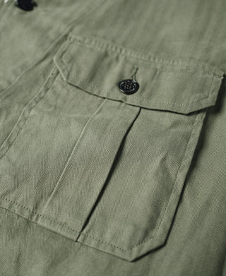 Olive fatigue jacket front flap with black snap button