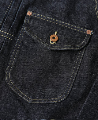 Indigo denim jacket chest pocket with brass-look button and bartack stitching