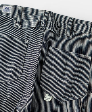 Striped carpenter pants with buttoned fly, belt loops, and flap chest pocket