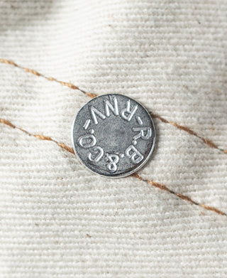 Embroidered canvas lining with round metal button and tan stitched edge