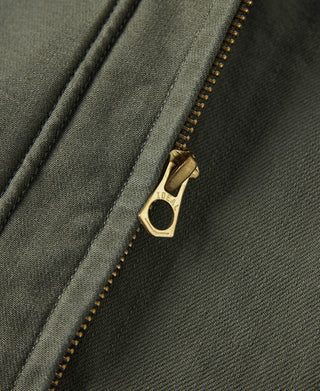 Olive jacket front zipper with gold-tone pull and dark topstitching