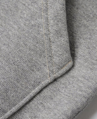 Gray terry sweatshirt side seam and curved pocket edge close-up
