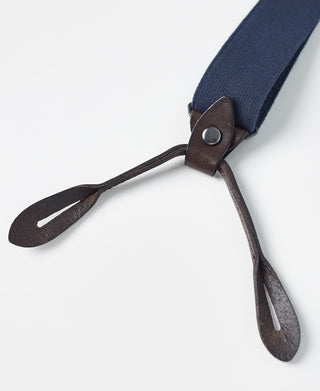 Navy suspender strap with brown leather adjuster and two prong ends