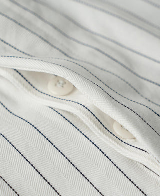 White pinstripe pants close-up showing belt-loop area and inner placket