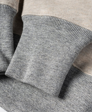 Oatmeal sweatshirt waistband and gray ribbed cuff band fold detail