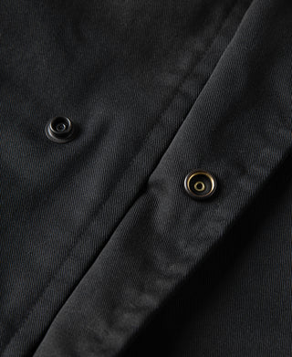 Black all-weather trench coat sleeve placket with contrasting grommet-style buttons