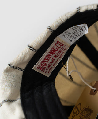 White newsboy cap interior showing inner care label and hanging tag