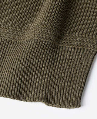 Olive wool sweater hem with ribbed knit cuff and textured stitching