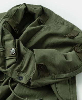 Olive arctic trousers with elastic waist, button tabs, and lined utility pocket openings