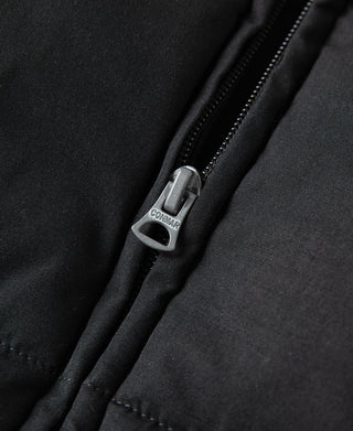 Black vest zipper with metal pull featuring engraved logo