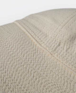 White WWII-style dixie cup hat, close-up of textured fabric