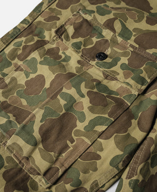 Camouflage pants knee area with stitched flap pocket and dark button