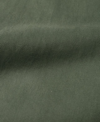 Olive officer trousers fabric close-up with fine woven texture