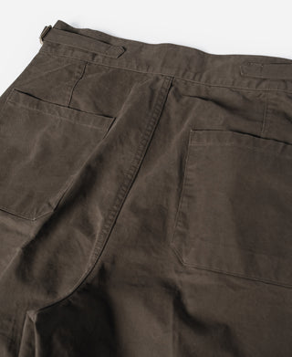 Brown combat pants with back pockets, pleated panel, and button waistband