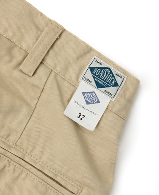 Khaki chino waistband close-up with brand label and belt loops