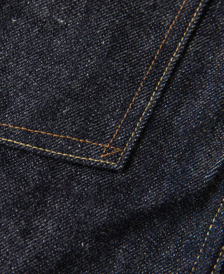 Indigo denim corner pocket seam with contrast stitching and folded hem detail