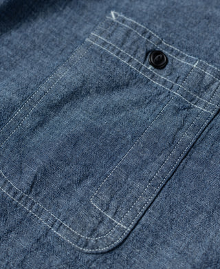 Blue chambray work shirt front chest pocket with curved welt and button