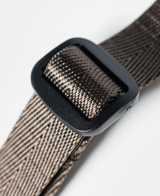 Adjustable buckle on textured woven webbing strap for olive chalk bag